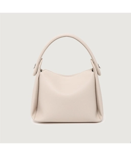 Detailed macro shot of off-white lychee grain leather and silver hardware on a handbag