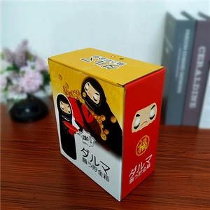 Detail of the Japanese Daruma money box packaging featuring the No-Face cartoon character