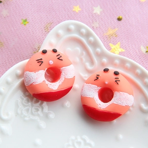 Macro view of colorful resin donut charms with cute expressions for DIY crafting
