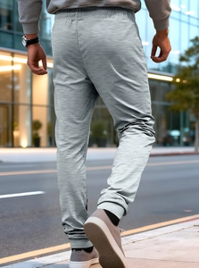 Detailed back view of men's grey marl jogging pants with elasticated cuffs and textured fabric