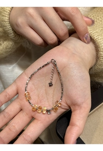 Detail of adjustable S925 sterling silver bracelet with yellow citrine beads on wrist