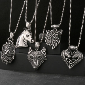 Detail view of vintage Viking pendants featuring lion, horse, and wolf head motifs