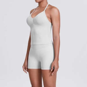 Detail view of white yoga set featuring V-neck tank top and high-waisted fitness shorts
