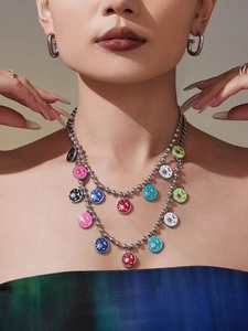 Detailed close-up of double-layer stainless steel necklace with colorful celestial pendants