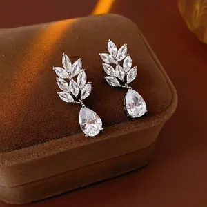 Elegant wheat leaf and teardrop zircon drop earrings on brown velvet jewelry box