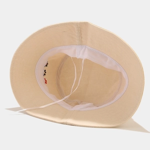 Beige cotton bucket hat featuring interior floral embroidery and adjustable size cord