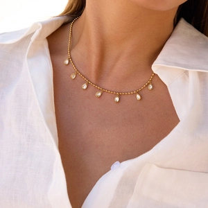 Elegant gold bead chain necklace featuring seven pear-cut cubic zirconia teardrop pendants