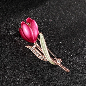 Detailed view of tulip brooch with pink enamel petals, green leaves, and crystal rhinestones