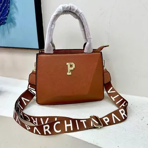 Brown faux leather tote bag with gold P logo and wide woven lettered strap