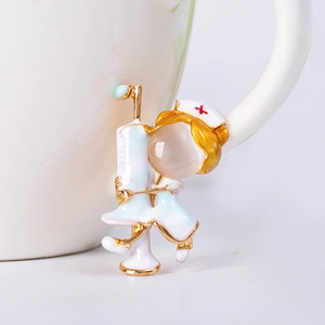 Macro shot of a medical nurse brooch with opal head and syringe on a white mug