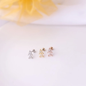 Detailed view of double triangle stud earrings in silver, gold, and rose gold finishes