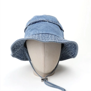 Close-up of light blue denim bucket hat with adjustable windproof cord and wide brim