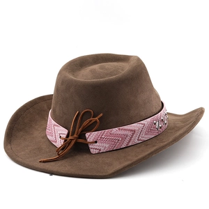 Close-up of brown suede cowboy hat featuring pink ethnic print band and metal rivets