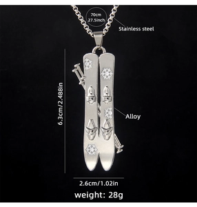 Detail view of silver ski and pole pendant with dimensions and stainless steel material