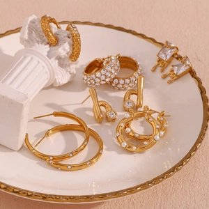 Detailed shot of gold plated earrings collection with pearls and sparkling crystals