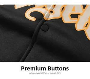 Detail of high-quality matte black snap button and artistic orange print on hoodie fabric