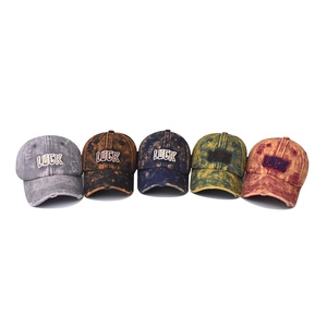 Five vintage washed baseball caps with LUCK embroidery in various distressed colors