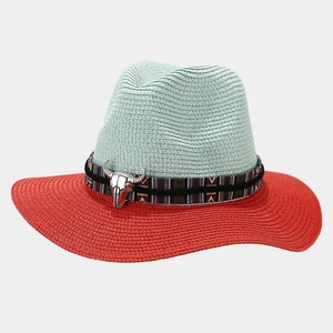 Detail of turquoise and red woven straw hat with tribal band and silver bull skull ornament