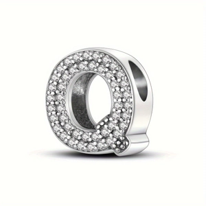 Close-up of sparkling silver letter Q charm with pave set diamonds for DIY jewelry