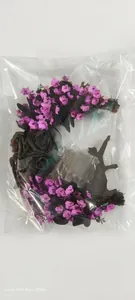 Detail of crescent moon cat wreath with purple flowers and battery operated LED lights