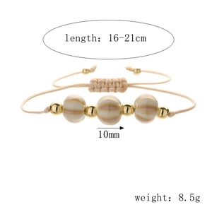 Detail of adjustable woven bracelet with brown striped beads and golden accents