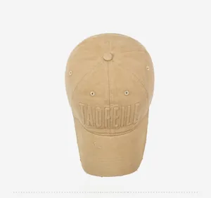 Close-up of khaki baseball cap featuring vintage distressed brim and 3D letter embroidery