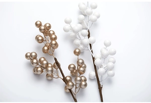 Detailed close-up of gold and white artificial Christmas berries branches for festive decor