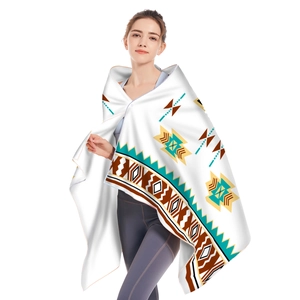 Detail of hooded microfiber beach towel featuring vibrant bohemian geometric patterns