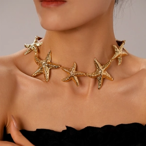 Gold starfish choker necklace with hammered metal texture for a beach vacation look