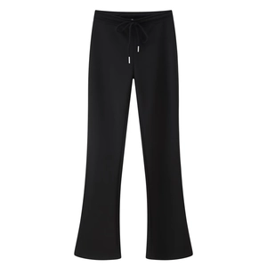 Detail of high-waist black flare yoga pants with drawstring and elastic texture