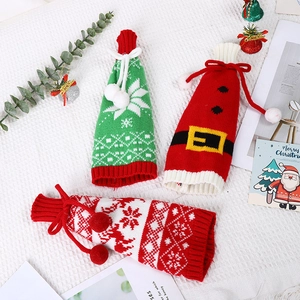 Detailed view of Christmas knit wine bottle covers with snowflakes and reindeer patterns