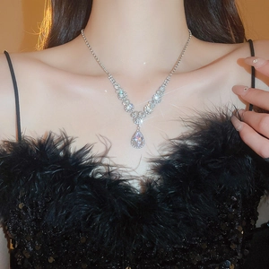 Close-up of elegant teardrop zircon pendant necklace on model's neckline