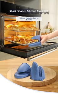Shark-shaped blue silicone oven mitt detail showing anti-slip grip for hot plates