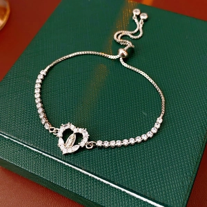 Detail view of silver heart bracelet with Virgin Mary relief and shiny cubic zirconia