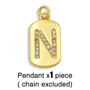 Detailed view of a gold N-letter pendant with pavé-set stones on a clean white background