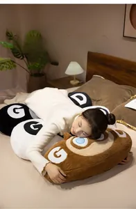 Close-up of long cartoon cat plush pillow with GD embroidery shown in a bedroom setting