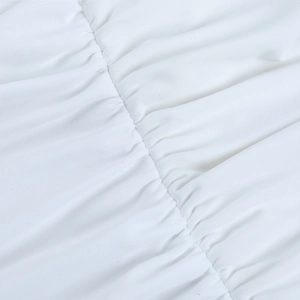 Detailed close-up showing the elegant ruched texture on a white off-shoulder summer dress