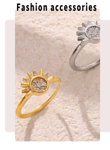 Detail of sun shaped gold and silver zircon rings on textured stone background