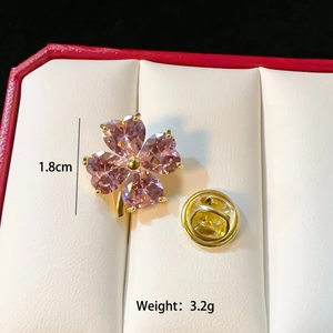 Detailed macro shot of 1.8cm pink clover brooch with butterfly clutch in a jewelry box