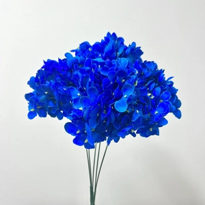 Detailed close-up of a blue artificial hydrangea stem with realistic fabric petals