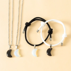 Detail of couple jewelry set with moon pendants and hand-woven yin yang ropes