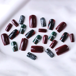 Halloween press-on nails set with red blood splatter, spider web, and vampire fang designs