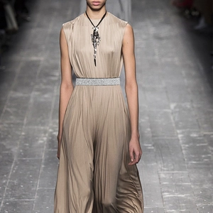 Close-up of elastic rhinestone wide belt with sparkling crystals on a khaki pleated dress