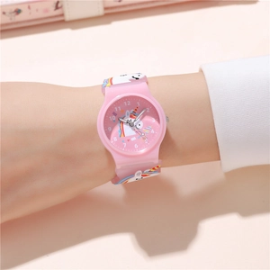 Close-up of pink quartz watch for kids with 3D unicorn pattern on a child's wrist