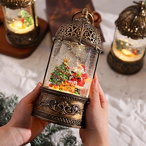 Vintage golden Christmas music box lantern with Santa Claus and sparkling snow globe