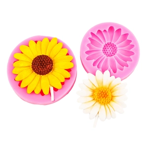 Detailed view of pink sunflower and daisy silicone molds with a realistic finished flower