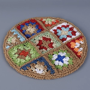 Detail showing colorful bohemian crochet patterns on a handmade woven beret hat