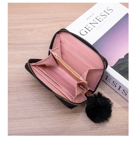 Detailed internal view of black women's quilted wallet showing pink card slots and zip pocket