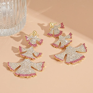 Macro view of gold-plated layered fan-shaped earrings with pink and white rhinestones