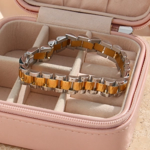 Detailed shot of two-tone steel link bracelet presented in a pink jewelry gift box